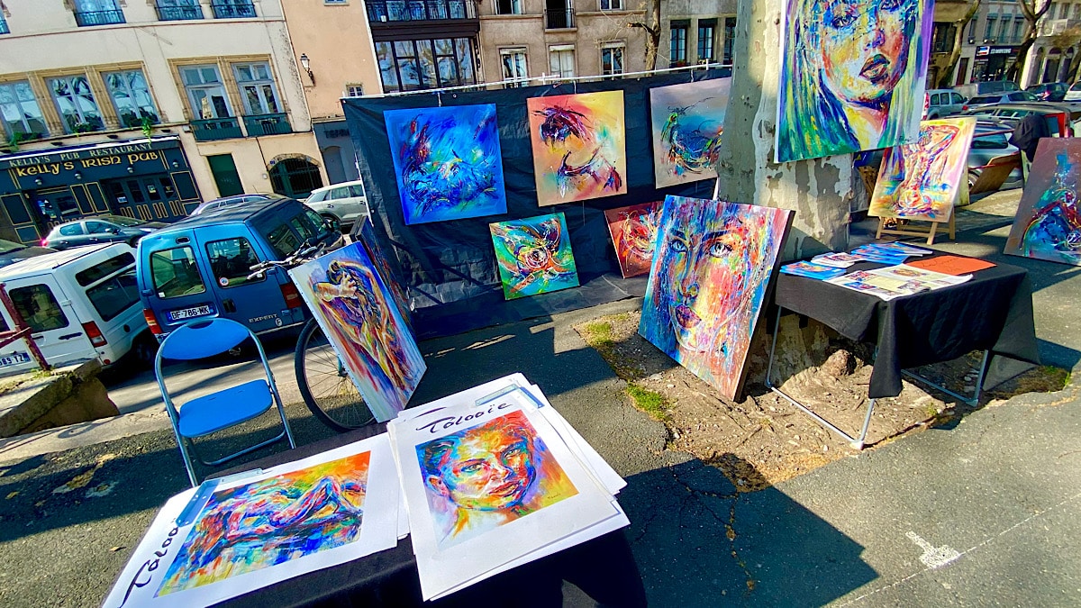 Les toiles d'un artiste exposées au marché de la Création, quais de Saône · Photo diffusée par Lyon Demain
